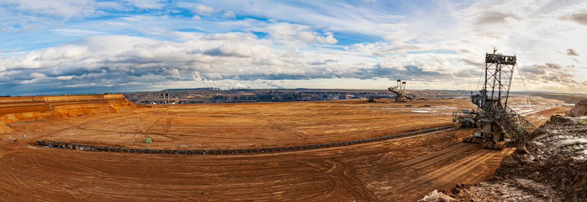 Aerial view of a northern open-pit mine with groundwater monitoring wells visible in surrounding terrain